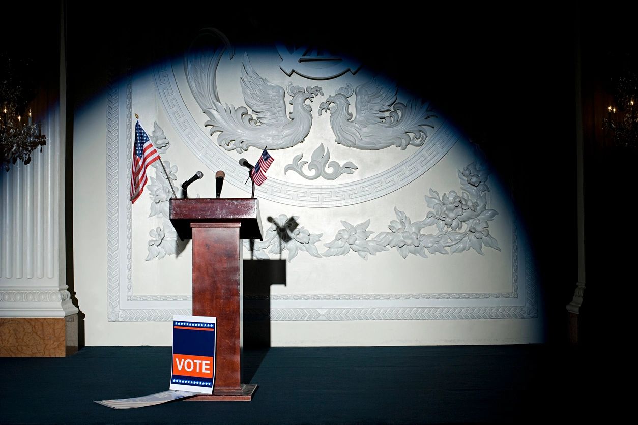 A podium with an american flag on it and a book.
