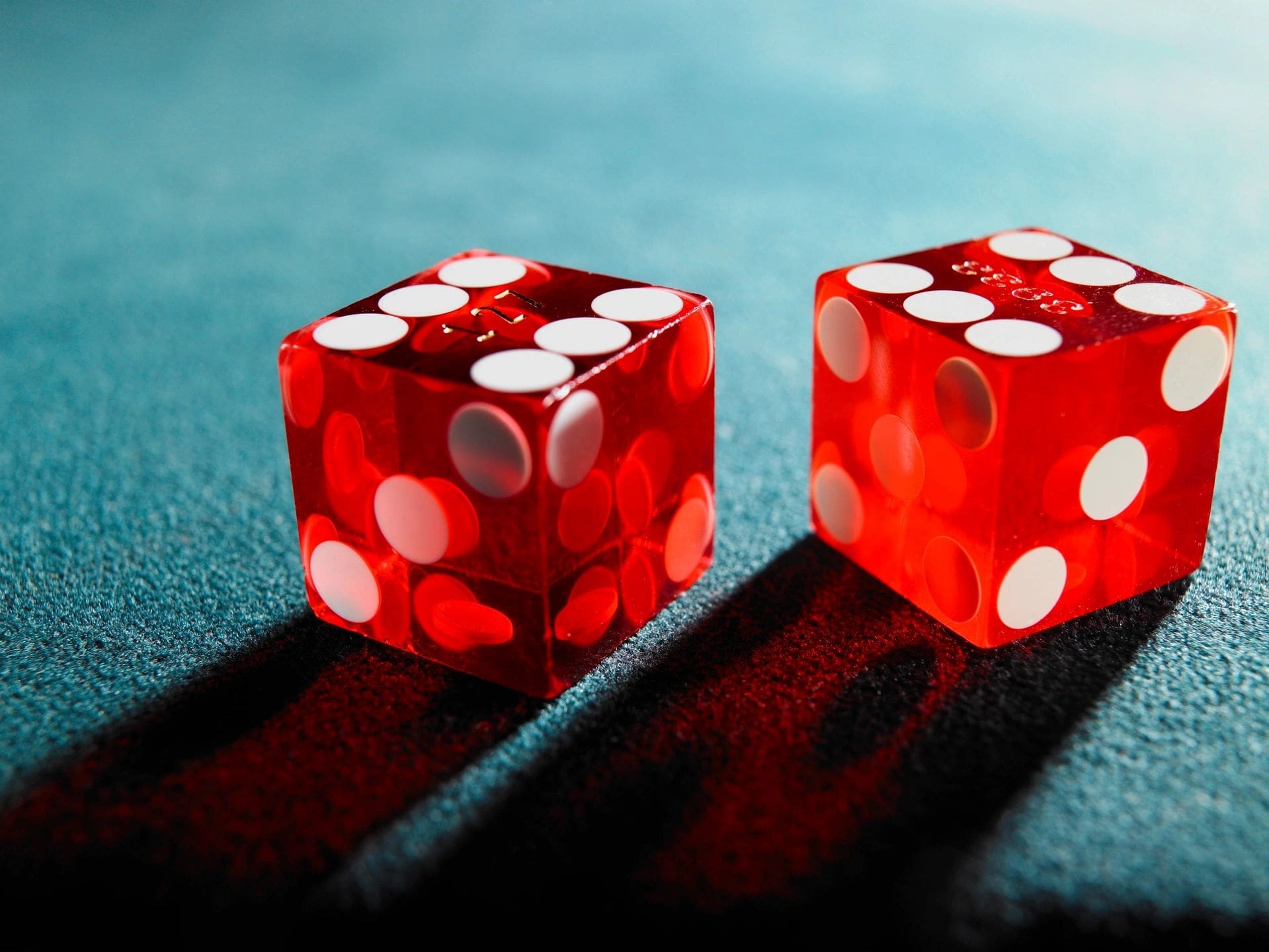 Two red dice sitting on top of a table.