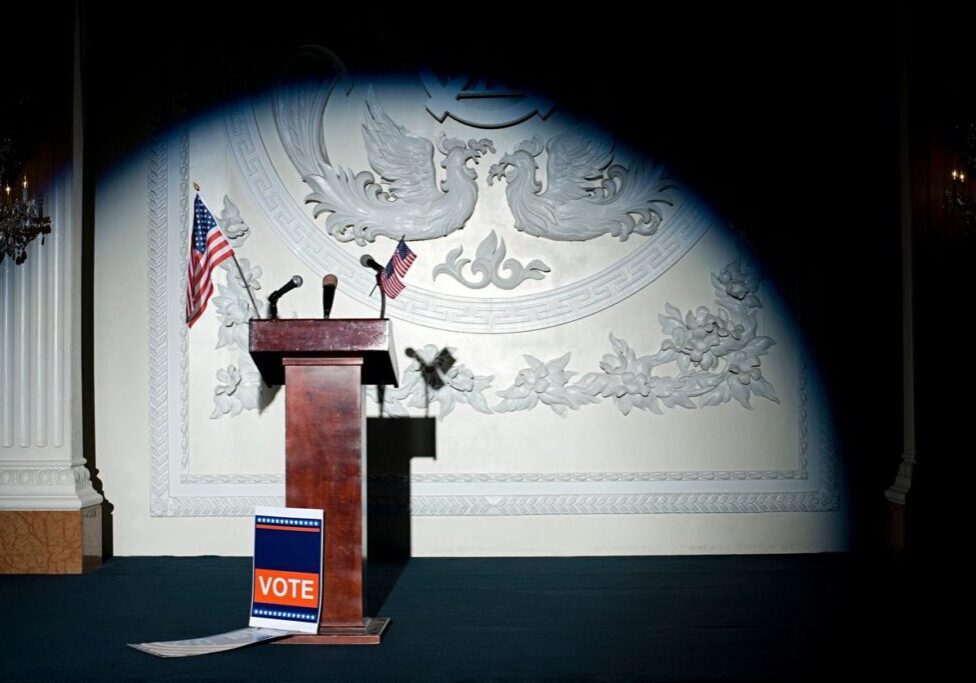 A podium with an american flag on it and a book.