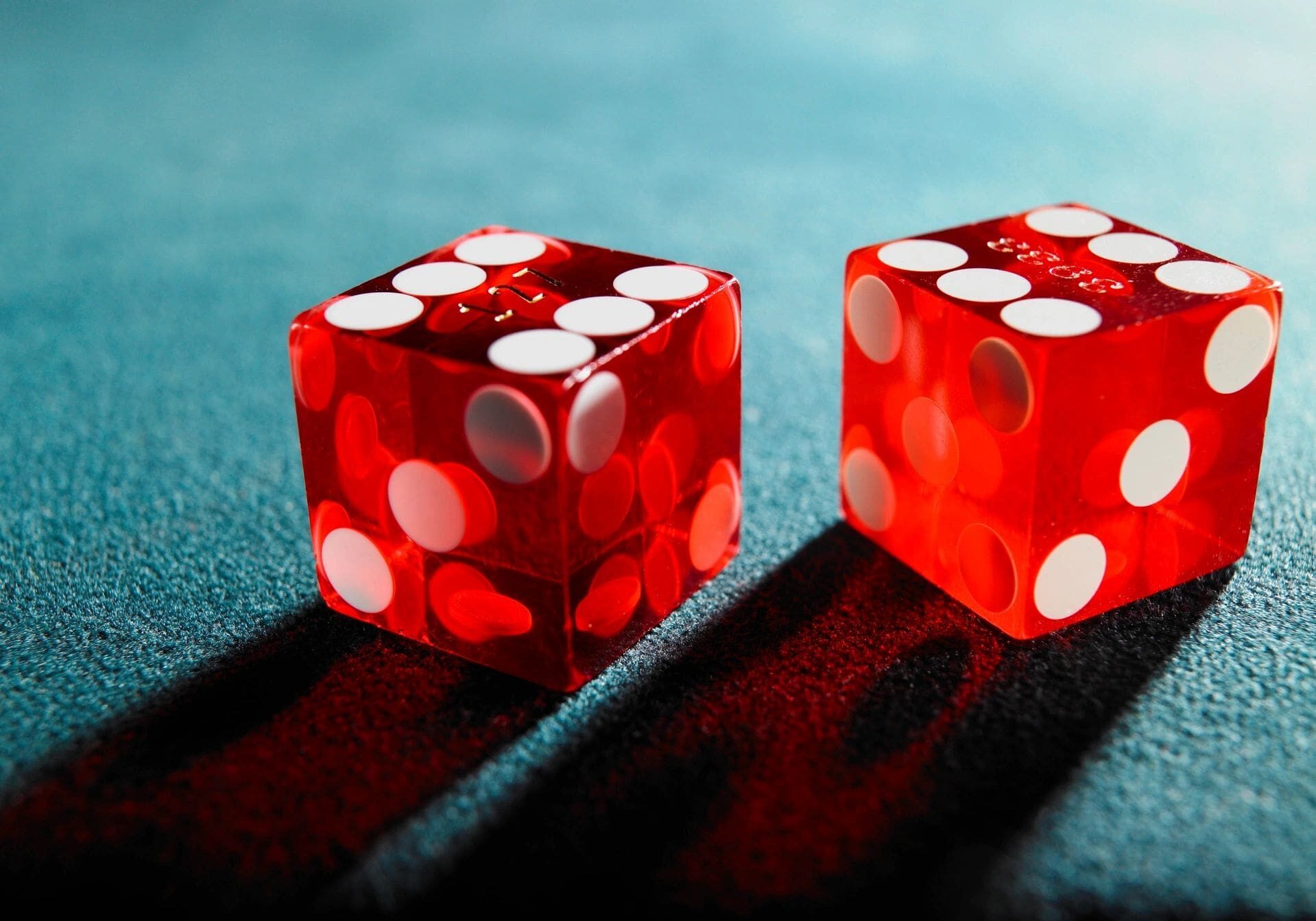 Two red dice sitting on top of a table.